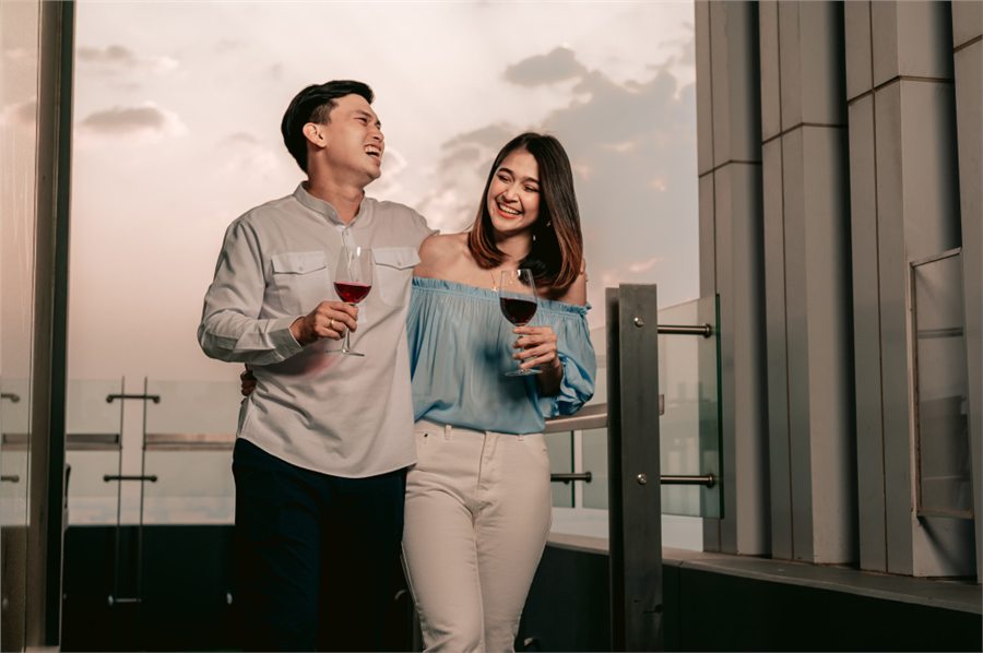 Confident Malaysian couple enjoying a rooftop date